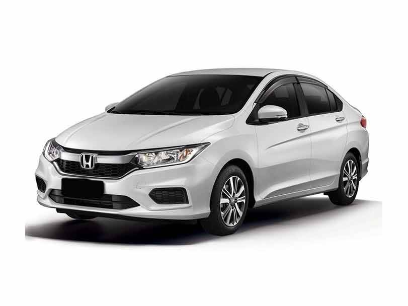 Front view of Honda City 2025 model in silver color, parked on road, showing sleek headlights, alloy wheels, and modern aerodynamic design.

